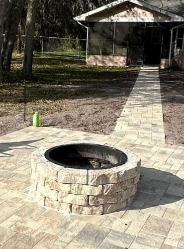 Cream and beige Fire pit with matching paver patio designed and installed by Suncoast Diamond Pavers in Tampa Florida