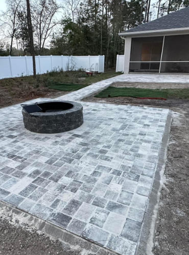 White Pewter Patio and walkway with Charcoal Fire Pit installed by Suncoast Diamond Pavers