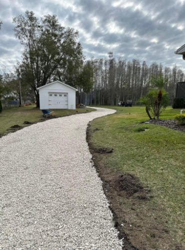 Straight back photo of inexpensive millings driveway next to backyard garage